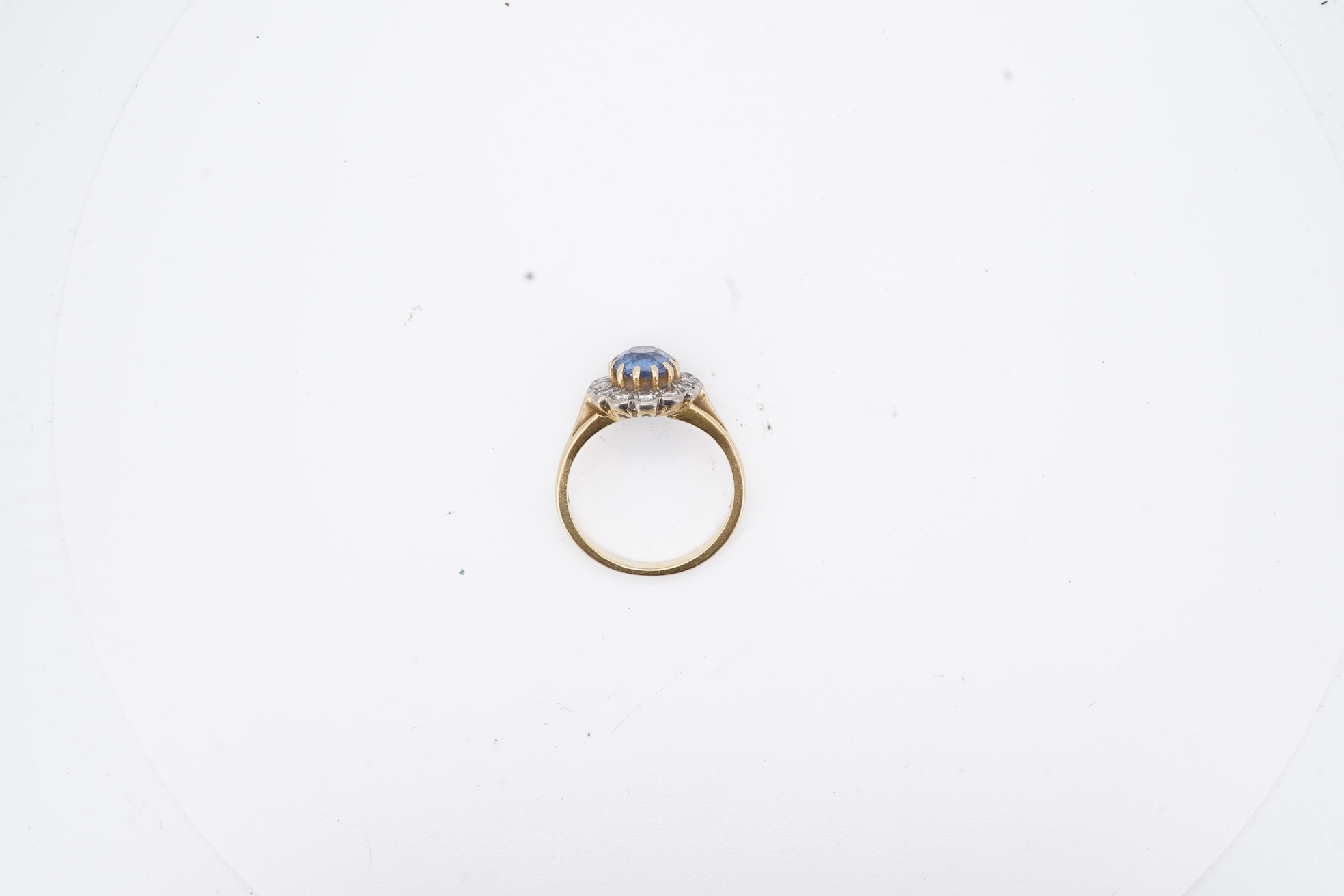A 1980's 18ct gold, sapphire and diamond set oval cluster ring, size K, gross weight 3.8 grams.